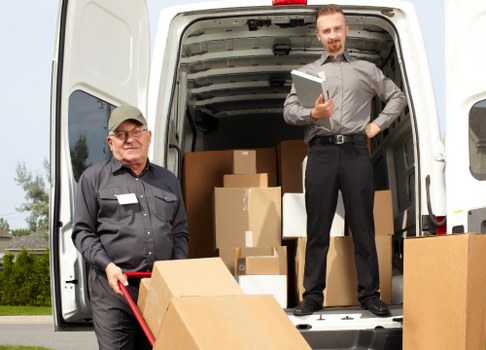 Professional movers handling household furniture in Preston