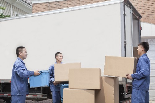 Trained van moving staff handling boxes during a Preston house move