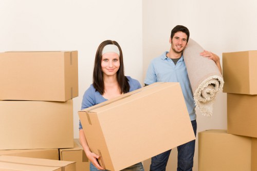 Packed household boxes and wrapped furniture ready for a Preston home move