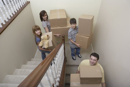 Helper carrying a sofa for a Preston man and van job